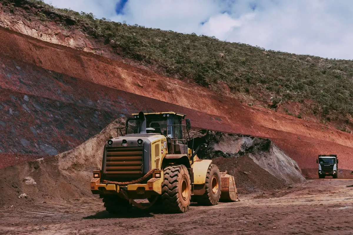 Wheel loader working a red earth cut