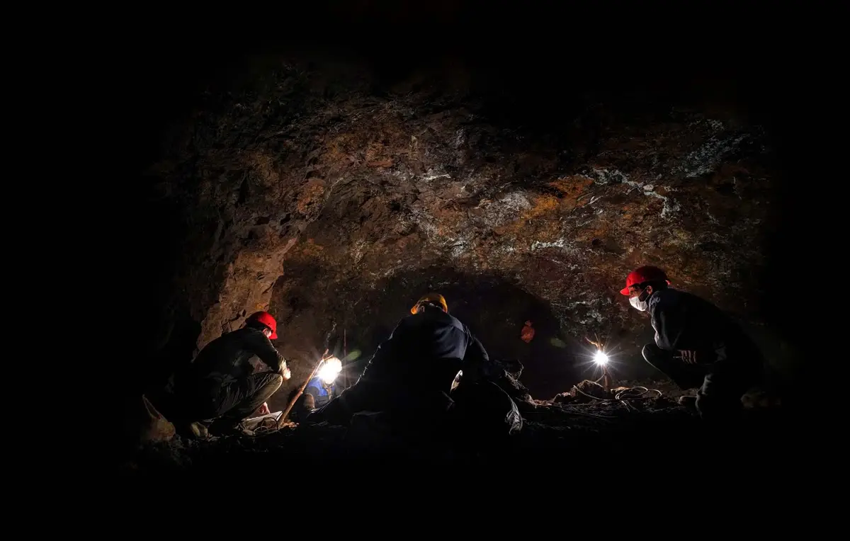 Miners with headlamps underground