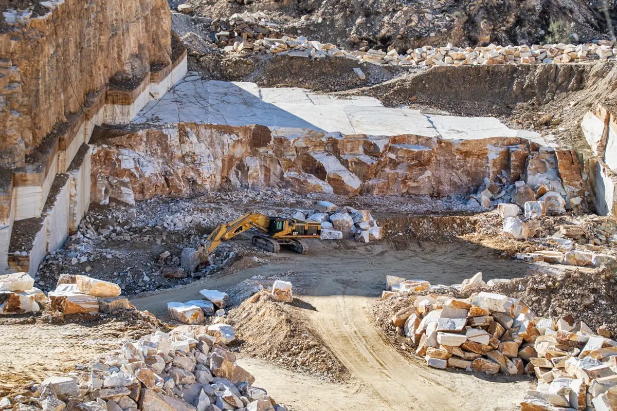 Excavator working quarry benches