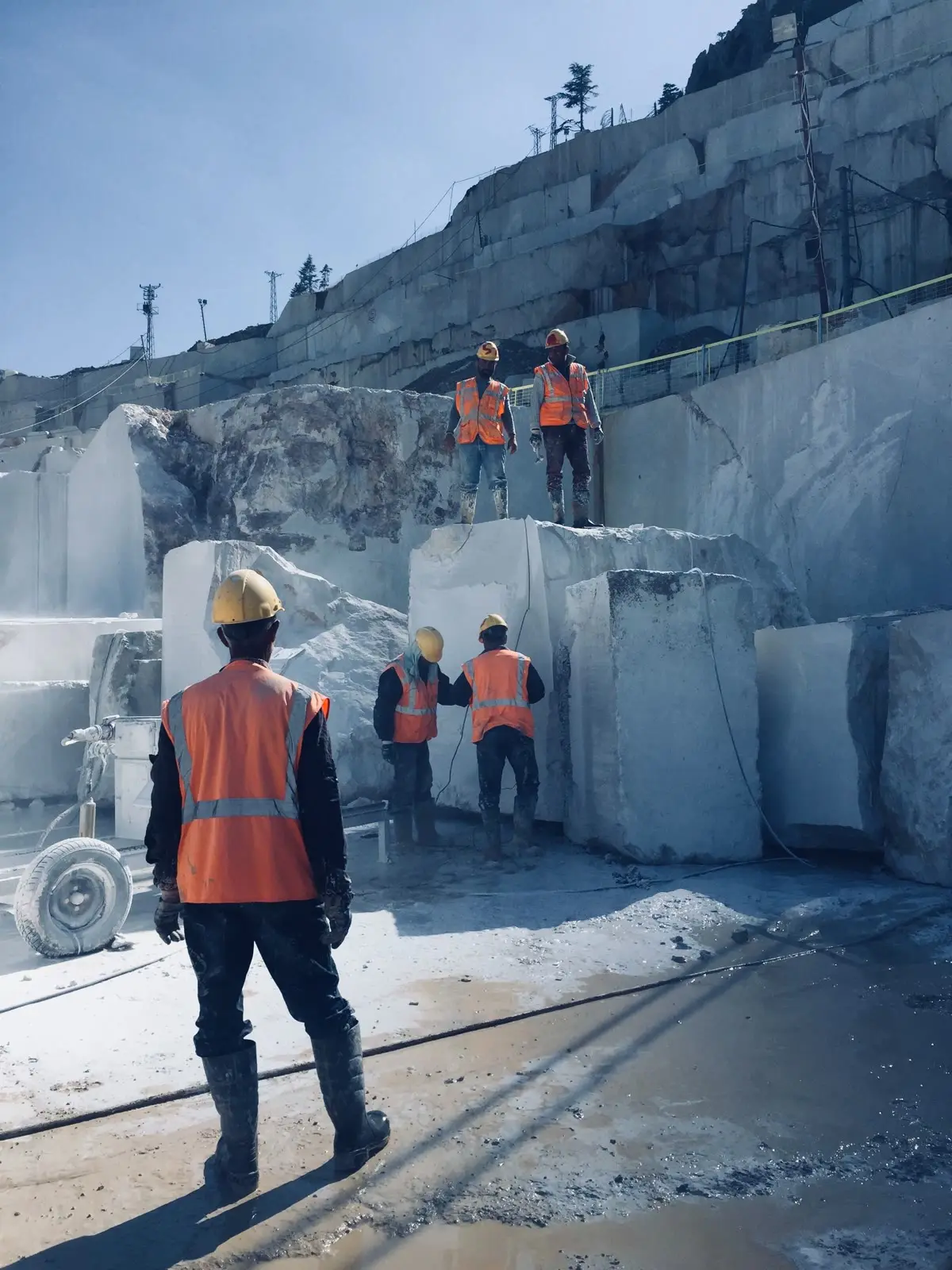 Crew in hard hats on a quarry face