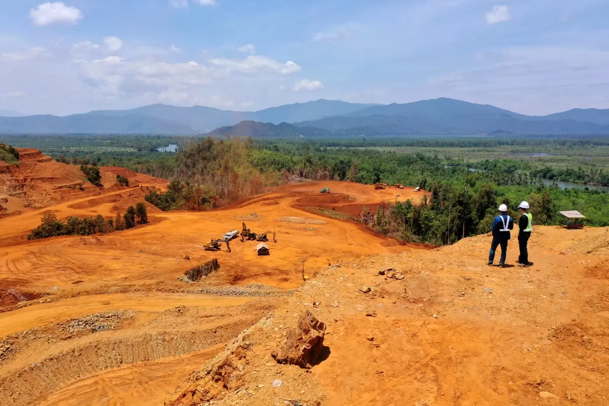 Two geologists surveying open ground